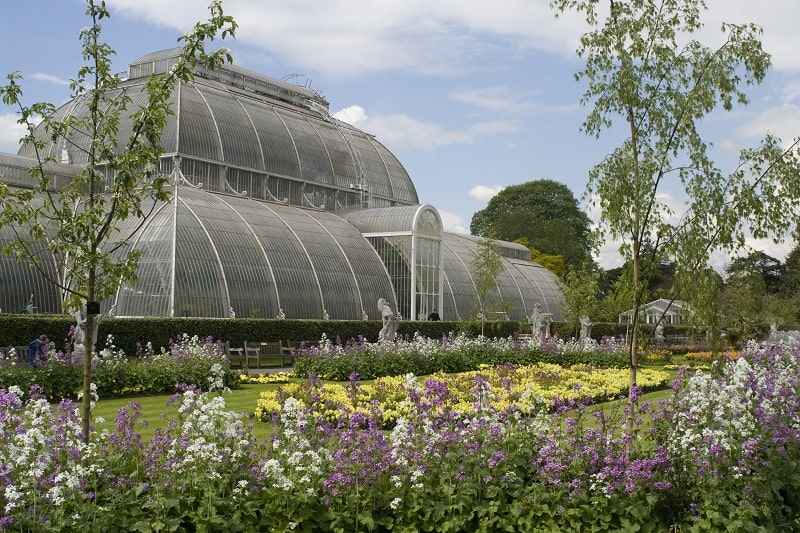 Kew Gardens Greenhouse in the summer with the garden in bloom